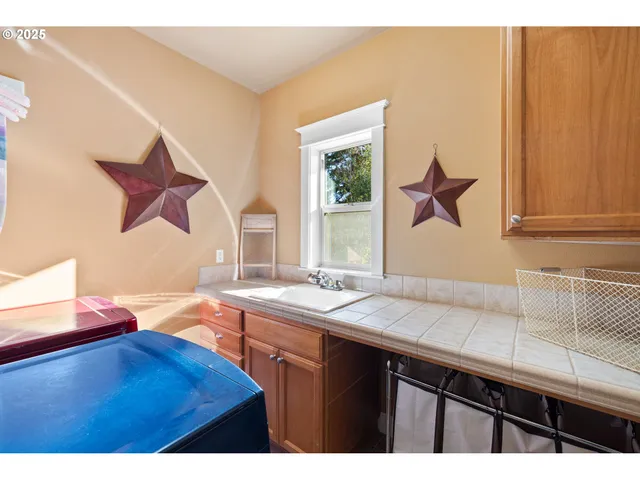 a kitchen with a sink and a wooden cabinets
