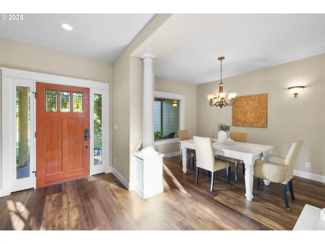 a living room with couches chairs and closet with wooden floor