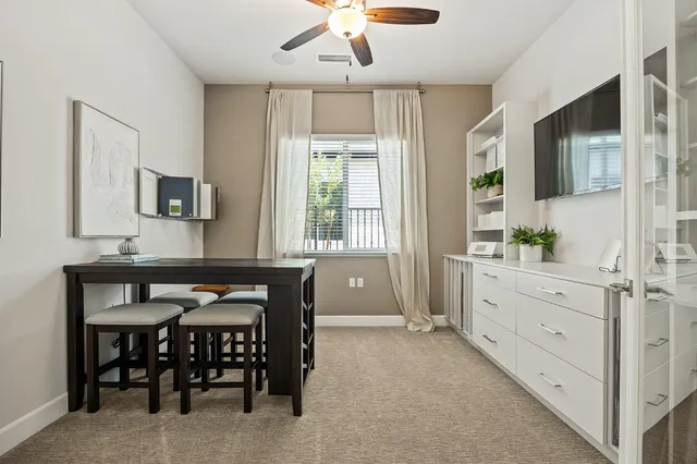 a dining room with furniture and window