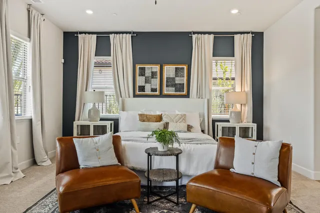 a living room with furniture and large windows