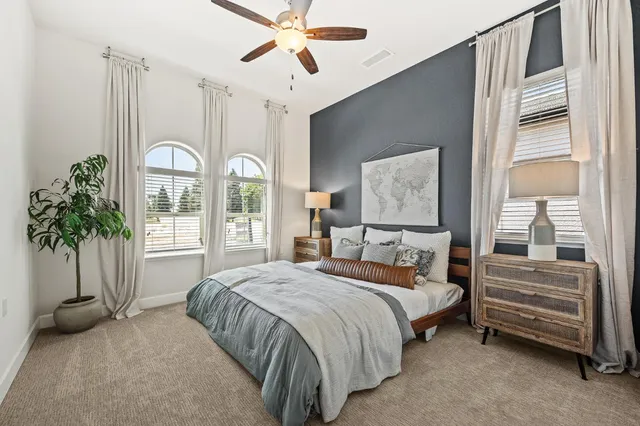 a bedroom with a bed and a chandelier