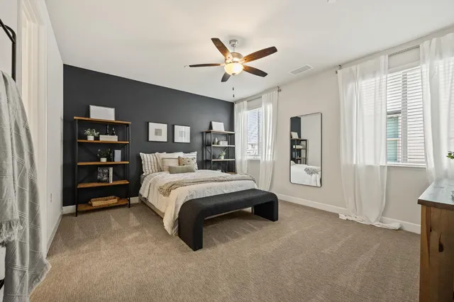 a spacious bedroom with a bed a window and closet
