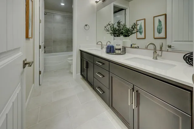 a bathroom with a double vanity sink mirror and shower