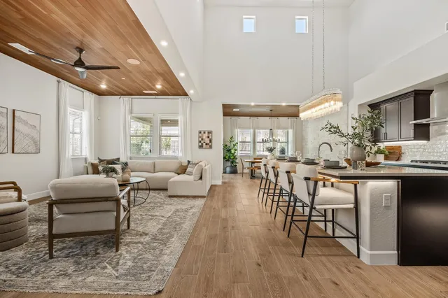a living room with lots of furniture and a wooden floor