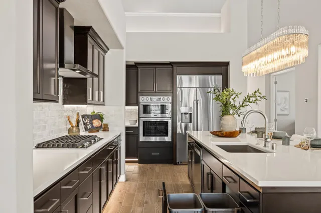 a kitchen with a sink stove and refrigerator