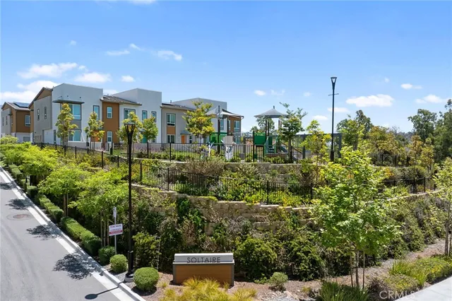 a view of a city that has lots of plants and couches