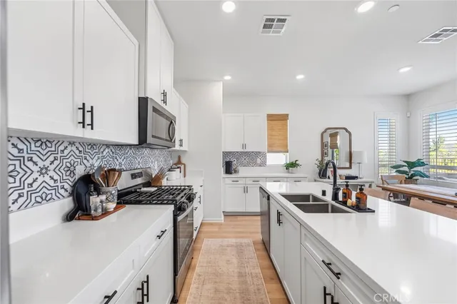 a kitchen with a sink stove and cabinets