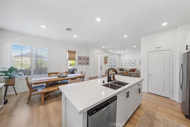 a kitchen with a sink a table and chairs