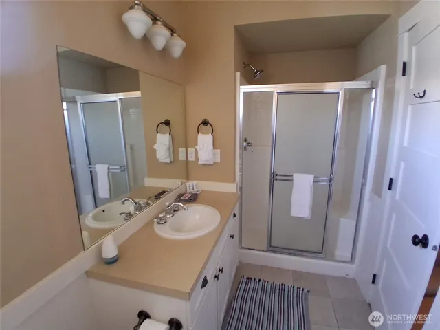 a bathroom with a sink vanity granite and a mirror