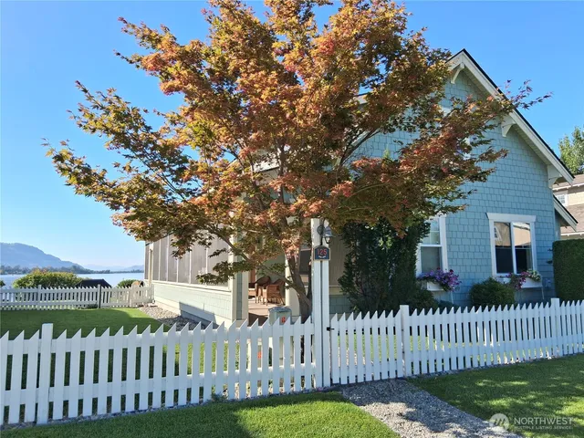 a front view of a house with a garden