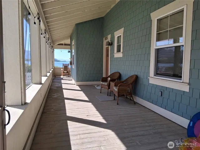 a lobby with furniture and two windows