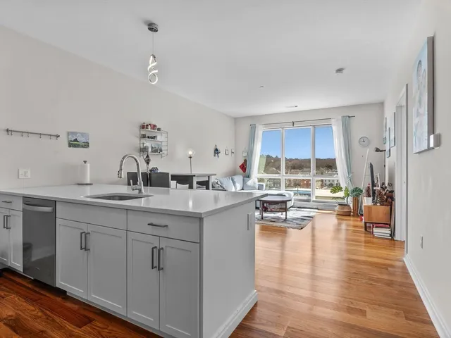 a kitchen with sink stove and cabinets