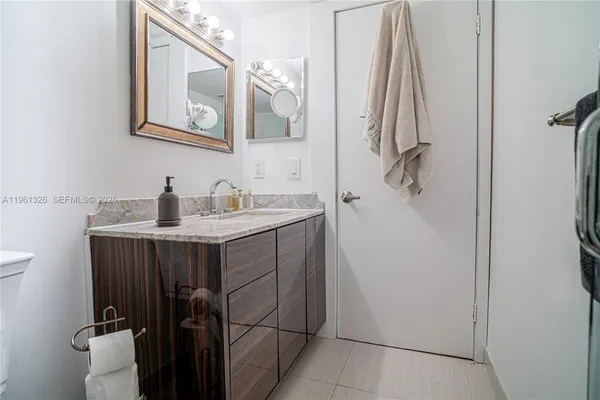 a bathroom with a sink vanity and a mirror