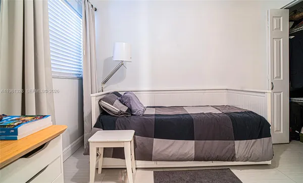a bedroom with a bed and a mirror