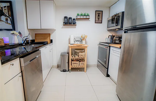 a kitchen with stainless steel appliances a refrigerator stove and sink