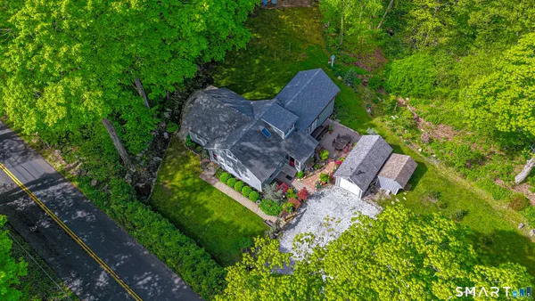 an aerial view of a house with garden space and street view