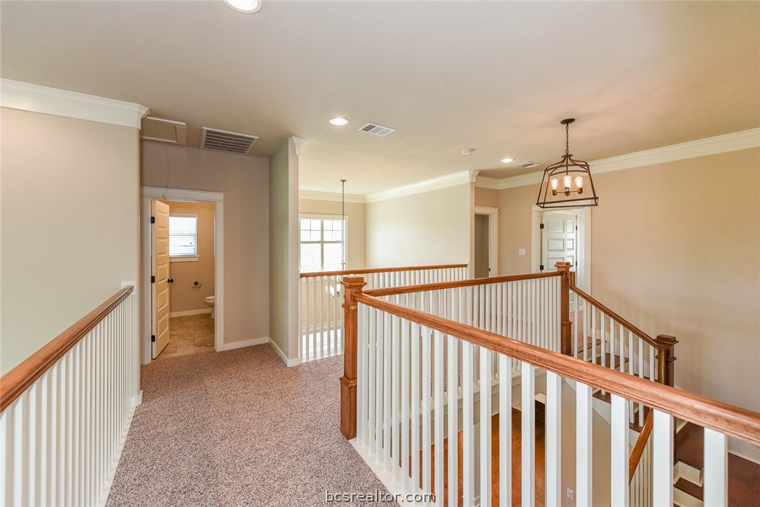 2136 Rockcliffe Loop College Station, TX 77845 - Photo 11 of 16 a view of a hallway to a room with wooden floor and stairs