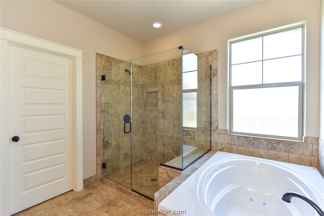 2136 Rockcliffe Loop College Station, TX 77845 - Photo 15 of 16 a bathroom with a tub shower and sink