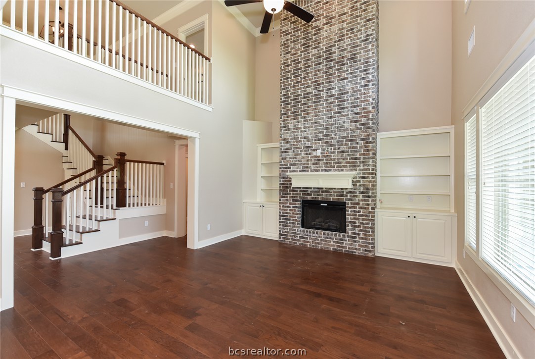 2136 Rockcliffe Loop College Station, TX 77845 - Photo 2 of 16 an entryway in a hall with wooden floor and a fireplace