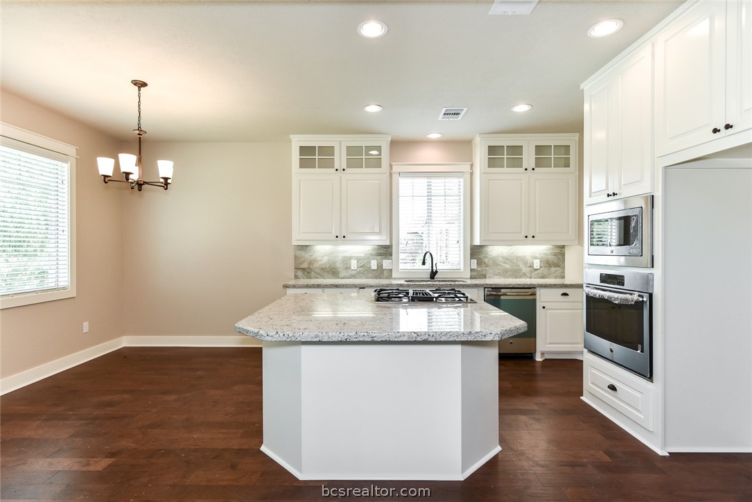 2136 Rockcliffe Loop College Station, TX 77845 - Photo 3 of 16 a kitchen with stainless steel appliances granite countertop a sink stove and refrigerator