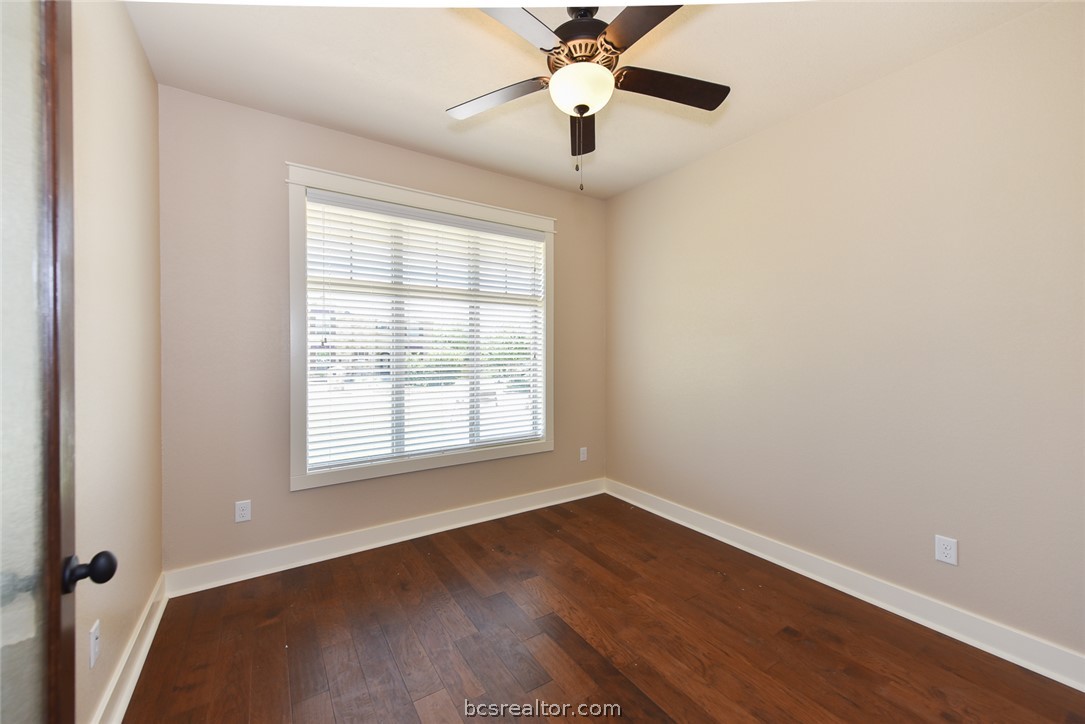 2136 Rockcliffe Loop College Station, TX 77845 - Photo 8 of 16 an empty room with wooden floor fan and windows