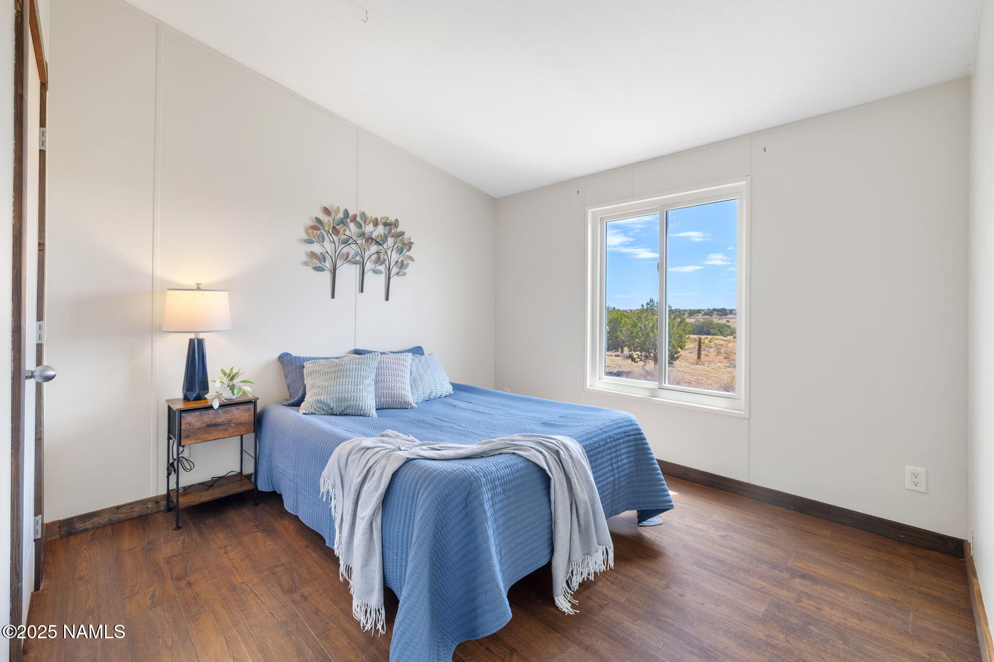 6792 South Quivero Road Williams, AZ 86046 - Photo 14 of 35 a spacious bedroom with a bed and a window