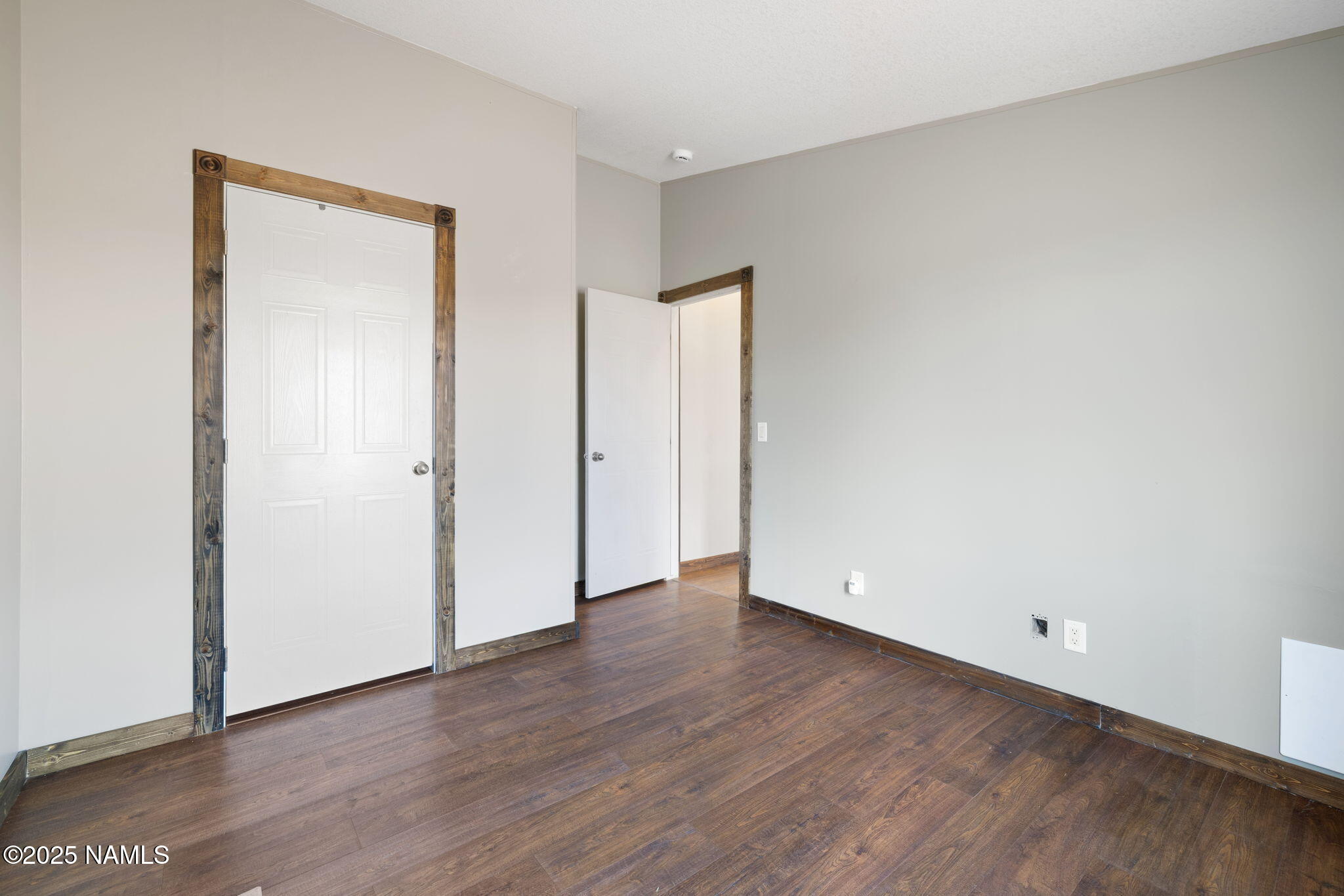 6792 South Quivero Road Williams, AZ 86046 - Photo 17 of 35 an empty room with wooden floor & closet
