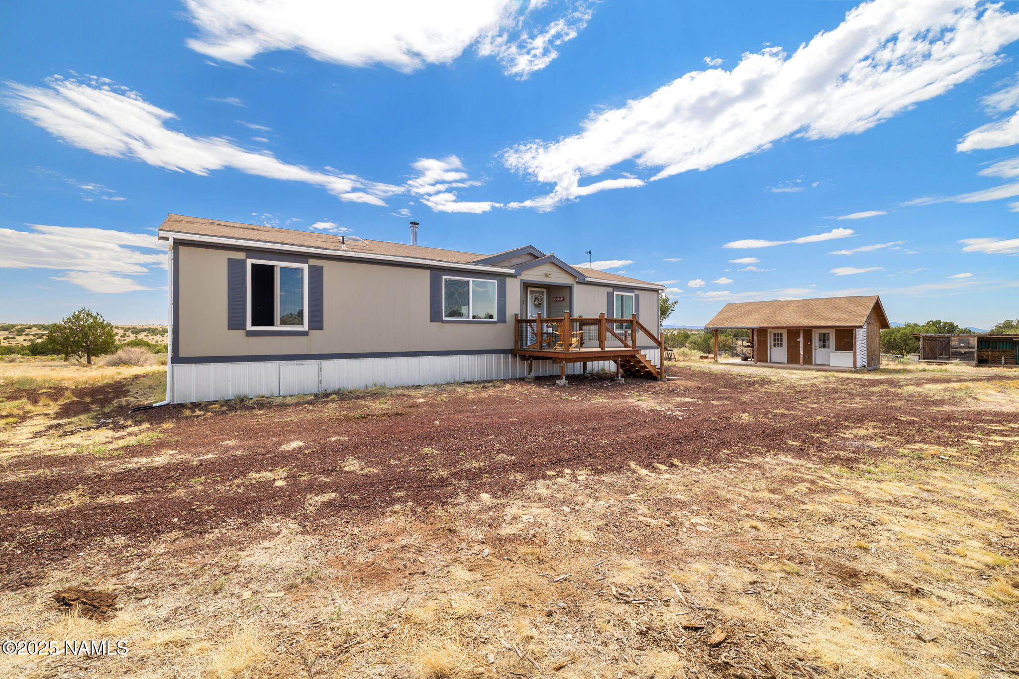 6792 South Quivero Road Williams, AZ 86046 - Photo 29 of 35 a front view of a house with a yard