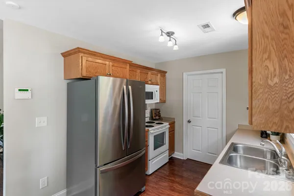 a kitchen with stainless steel appliances a refrigerator and a sink