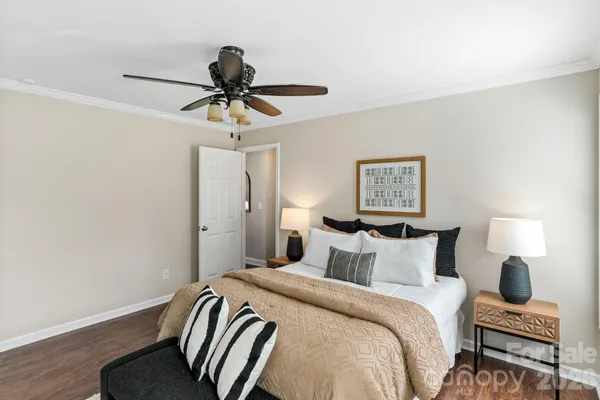 a bedroom with a bed and a chandelier