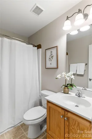 a bathroom with a sink toilet and mirror