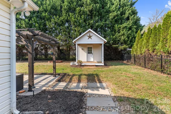 a view of house that has a big yard