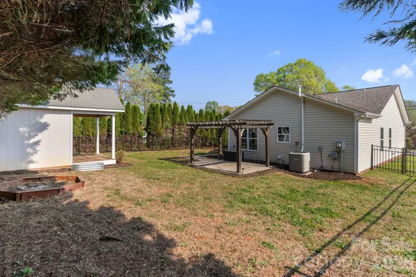 a view of a house with backyard and a patio