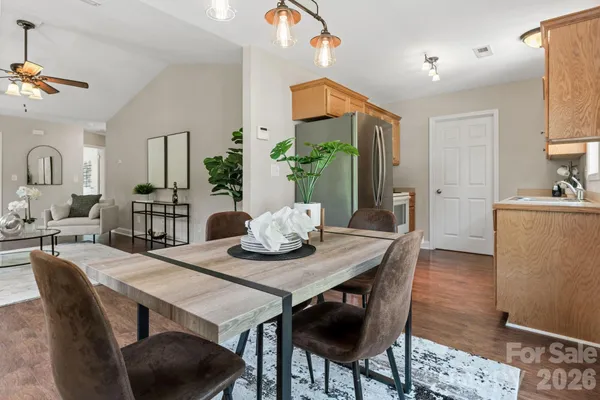 a view of a dining room with furniture and wooden floor