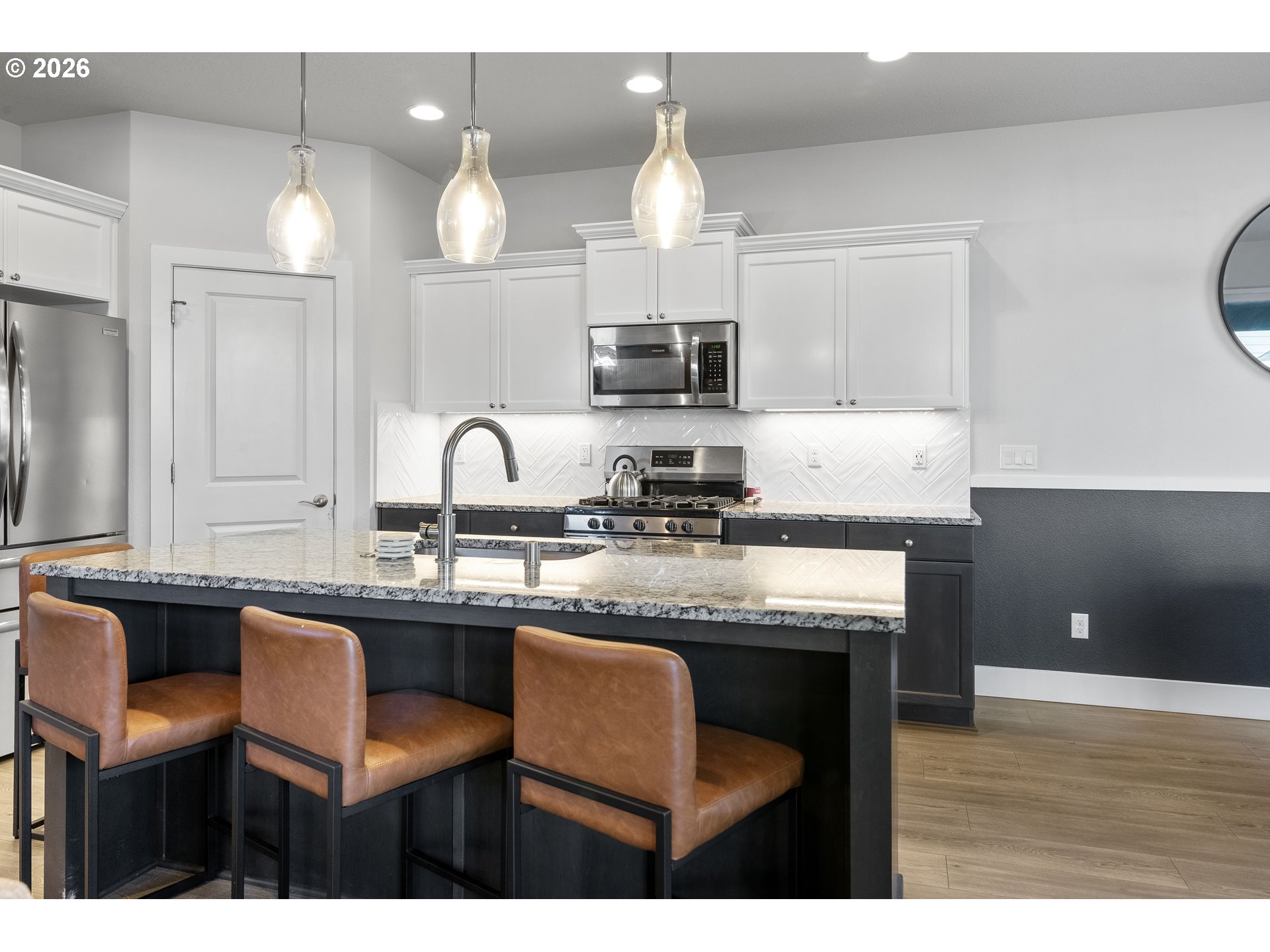 221 South 39th Drive Ridgefield, WA 98642 - Photo 11 of 35 a kitchen with stainless steel appliances granite countertop a sink a stove a dining table and chairs
