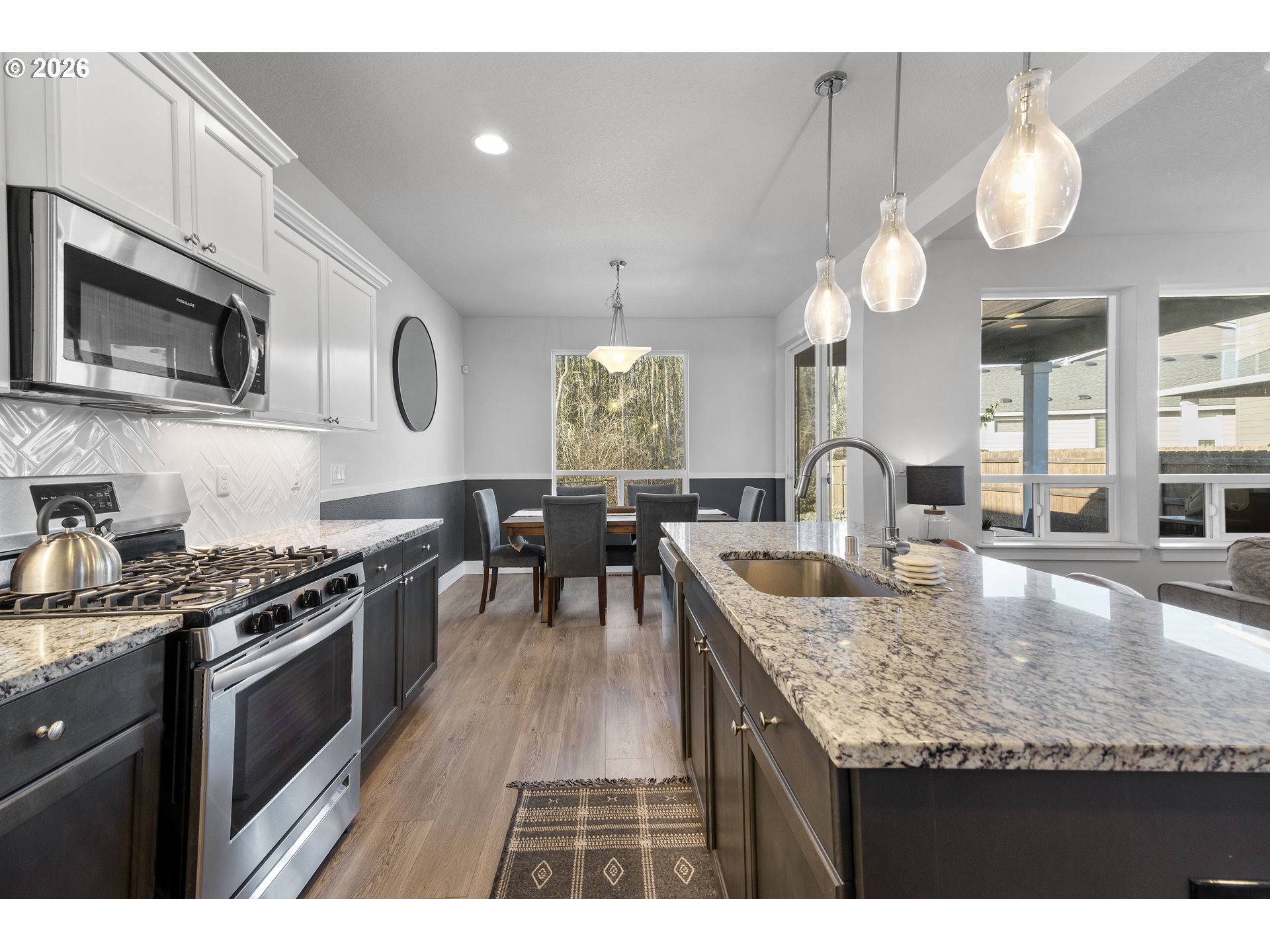 221 South 39th Drive Ridgefield, WA 98642 - Photo 14 of 35 a kitchen with stainless steel appliances granite countertop a stove a sink and a microwave