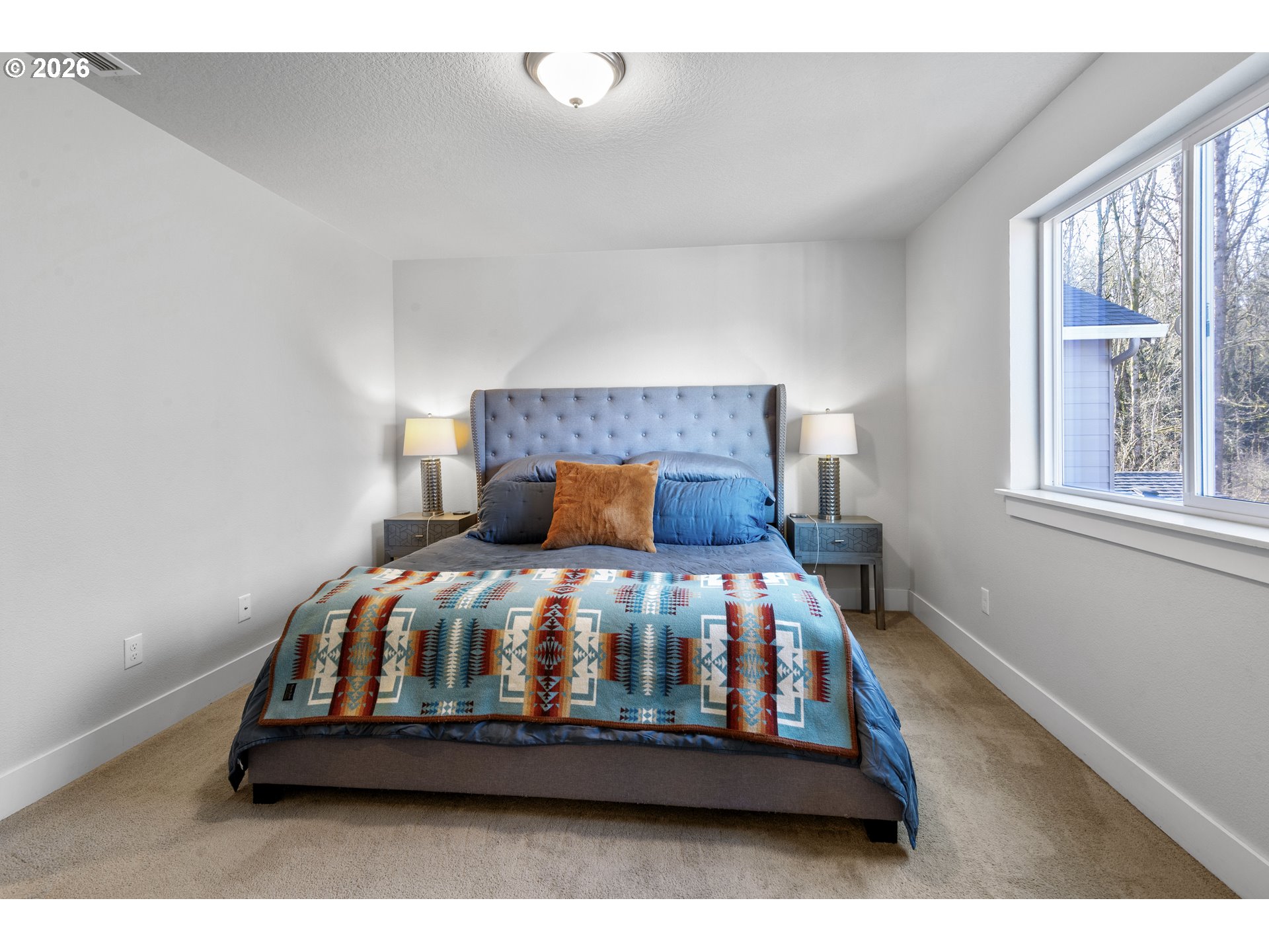 221 South 39th Drive Ridgefield, WA 98642 - Photo 25 of 35 a bed sitting in a bedroom next to a window