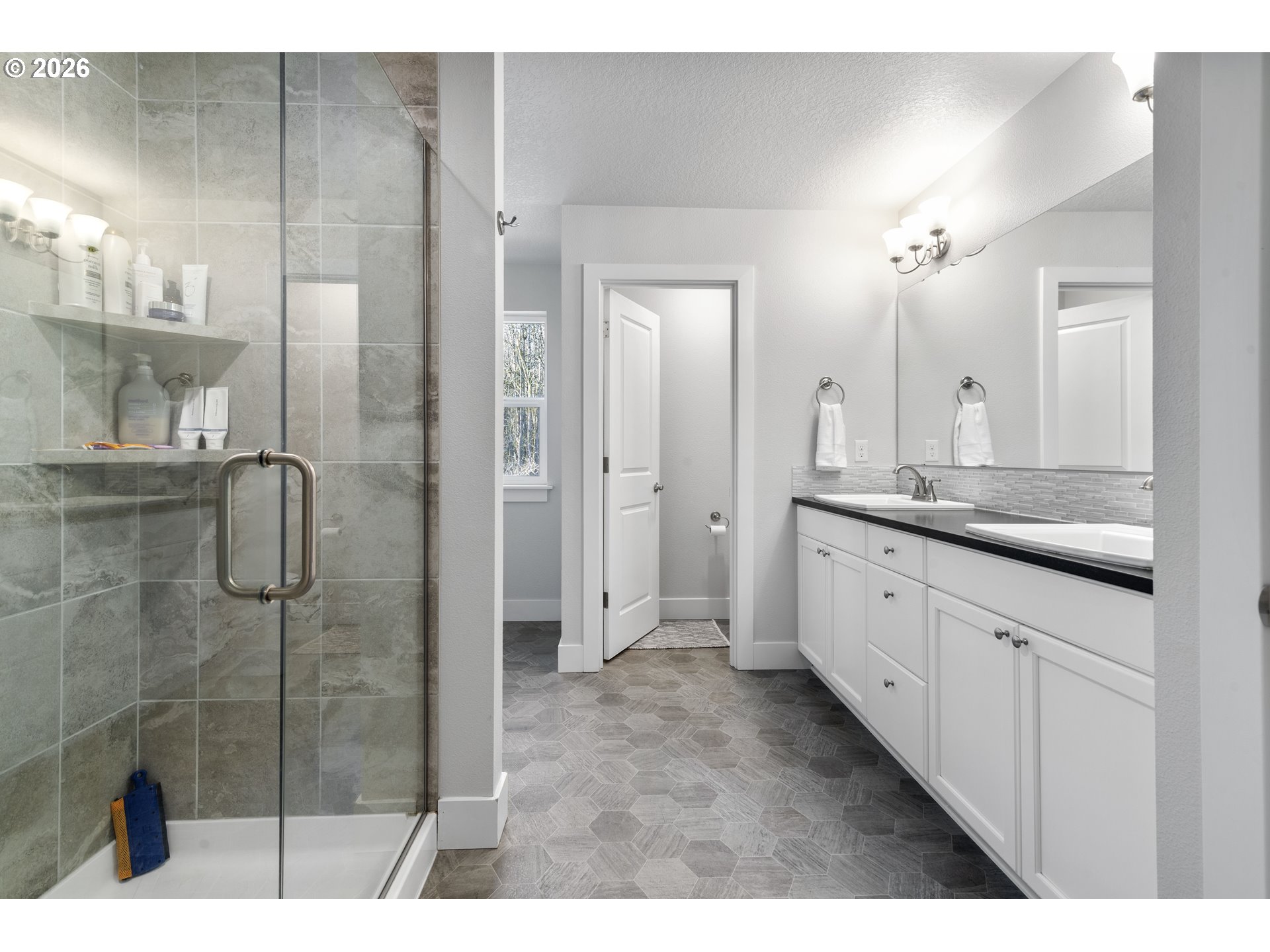 221 South 39th Drive Ridgefield, WA 98642 - Photo 28 of 35 a bathroom with a granite countertop sink mirror and shower