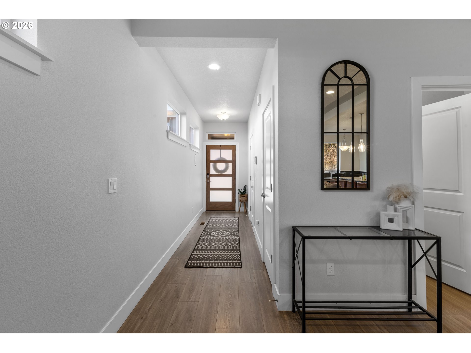 221 South 39th Drive Ridgefield, WA 98642 - Photo 4 of 35 a hallway with wooden floor chandelier and entryway