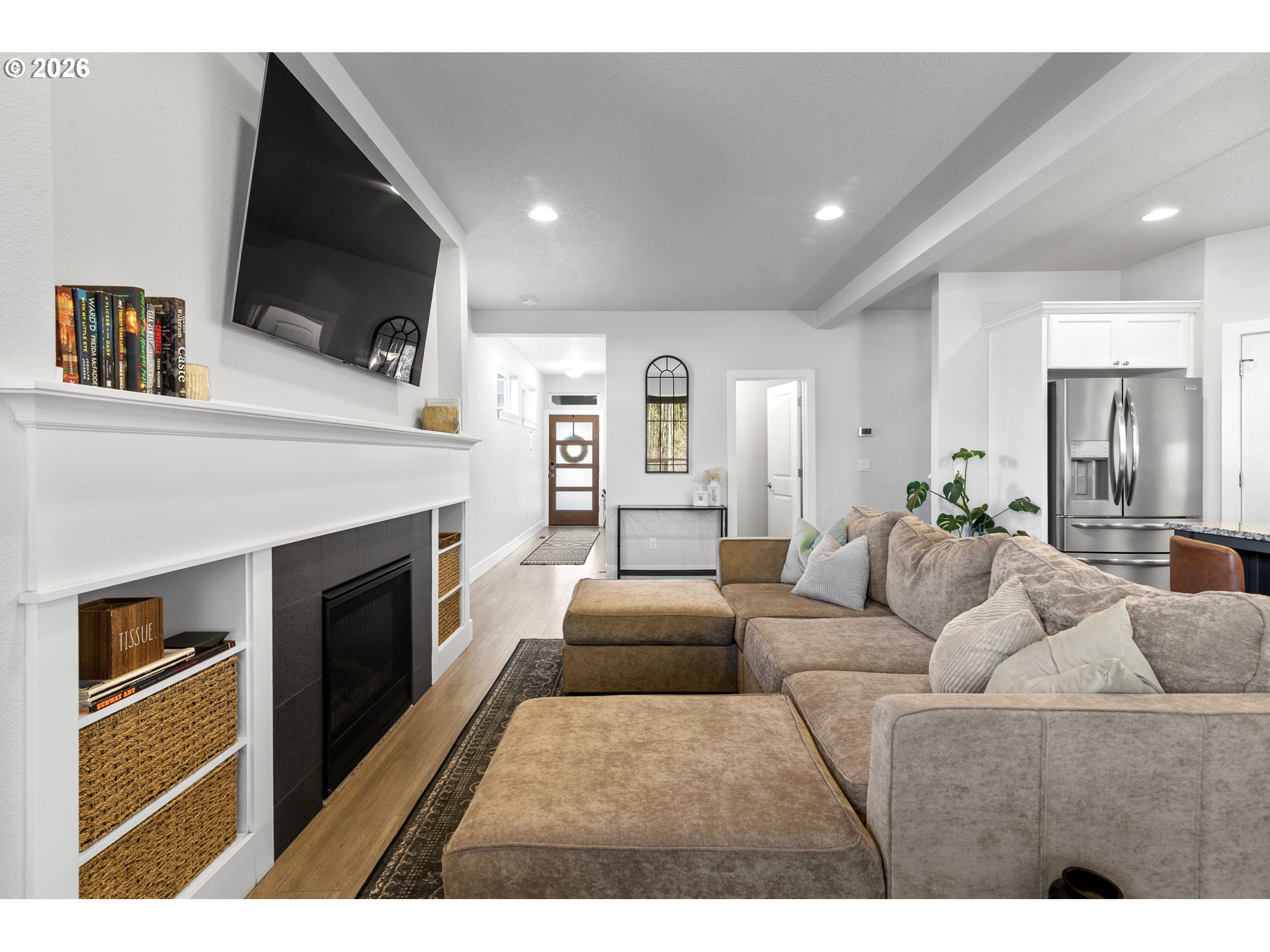 221 South 39th Drive Ridgefield, WA 98642 - Photo 7 of 35 a living room with furniture a flat screen tv and a fireplace