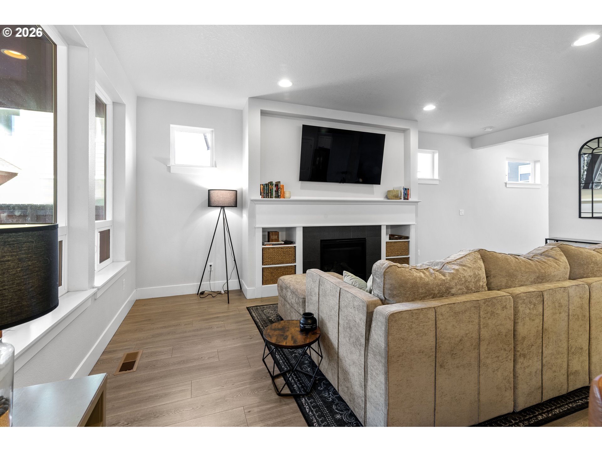 221 South 39th Drive Ridgefield, WA 98642 - Photo 8 of 35 a living room with furniture a flat screen tv and a fireplace
