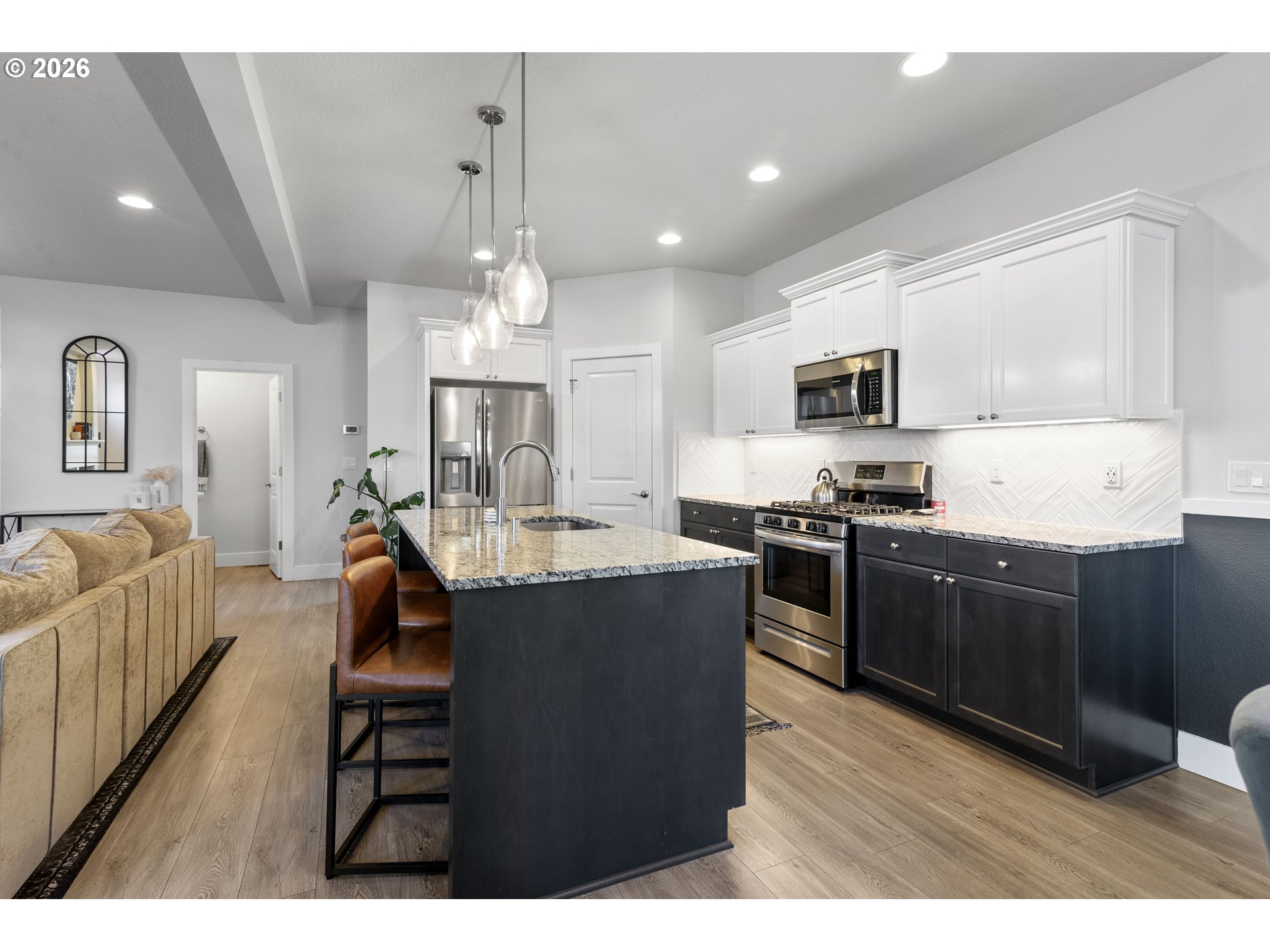 221 South 39th Drive Ridgefield, WA 98642 - Photo 9 of 35 a kitchen with kitchen island granite countertop a stove top oven a sink a dining table and chairs