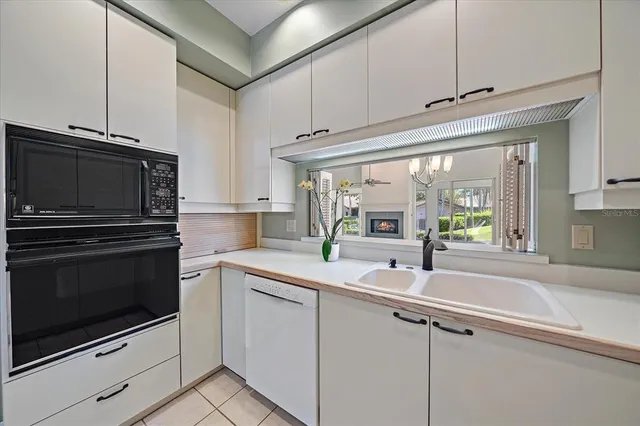 a kitchen with appliances a sink and cabinets