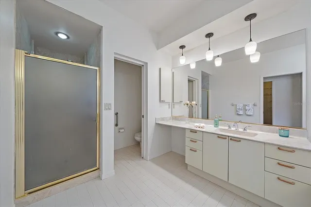 a spacious bathroom with a double vanity sink mirror and shower
