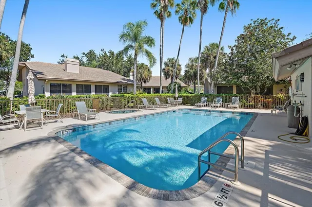 a swimming pool with outdoor seating and yard