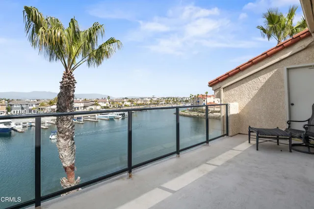 a room with furniture a large window and a chandelier