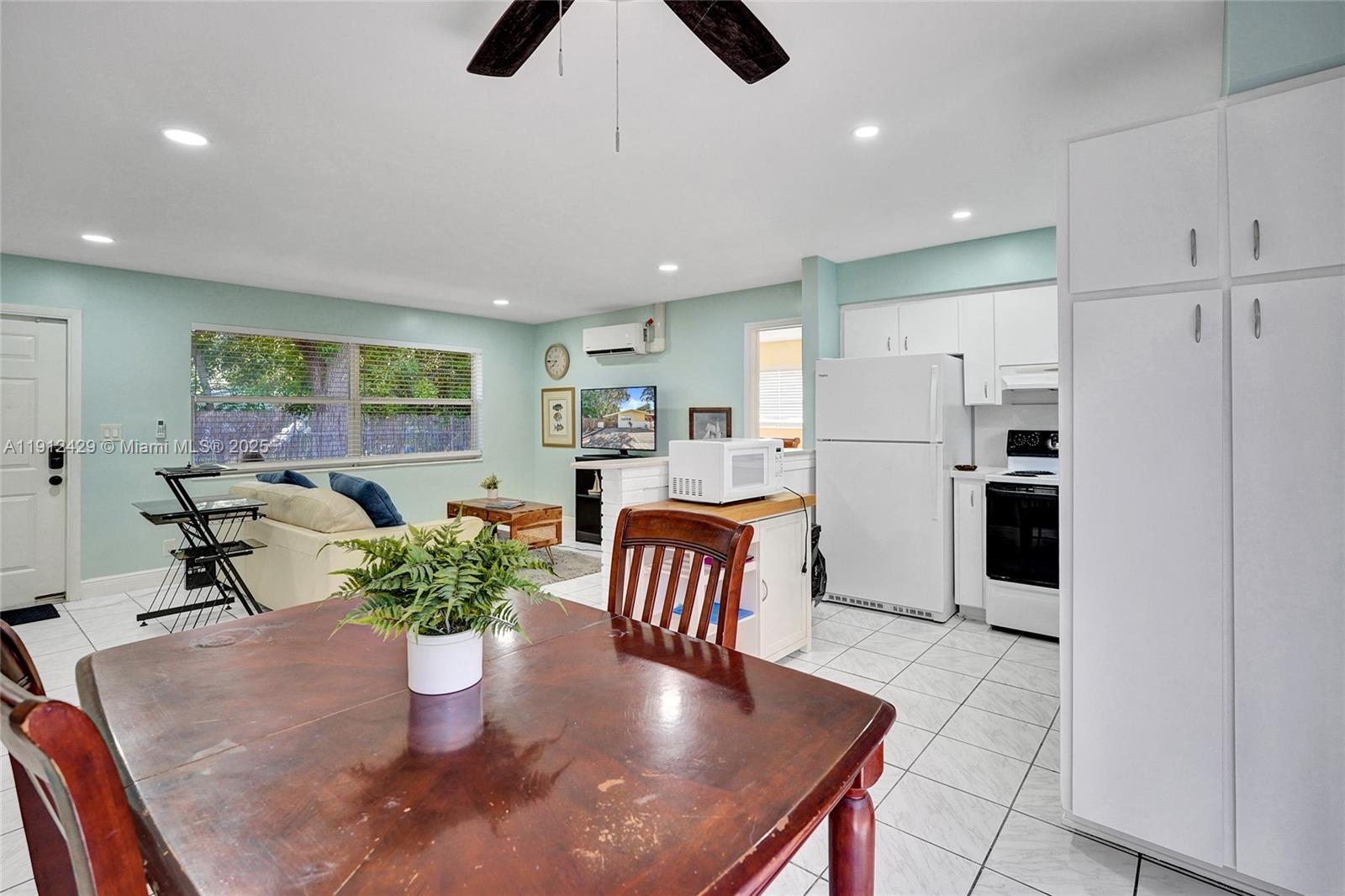 720 Southeast 15th Street, Unit 2R Fort Lauderdale, FL 33316 - Photo 12 of 33 a kitchen with stainless steel appliances granite countertop a refrigerator a sink a stove and island