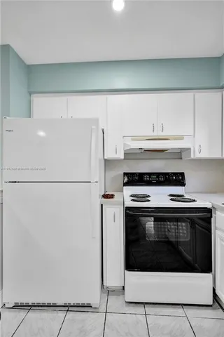 a kitchen with sink and cabinets