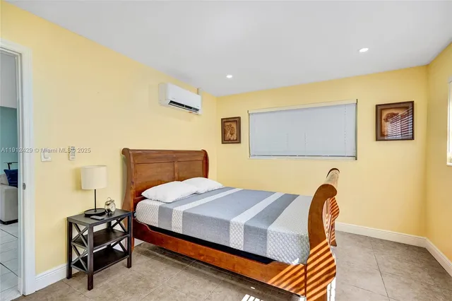 a bedroom with a bed and a dresser in it