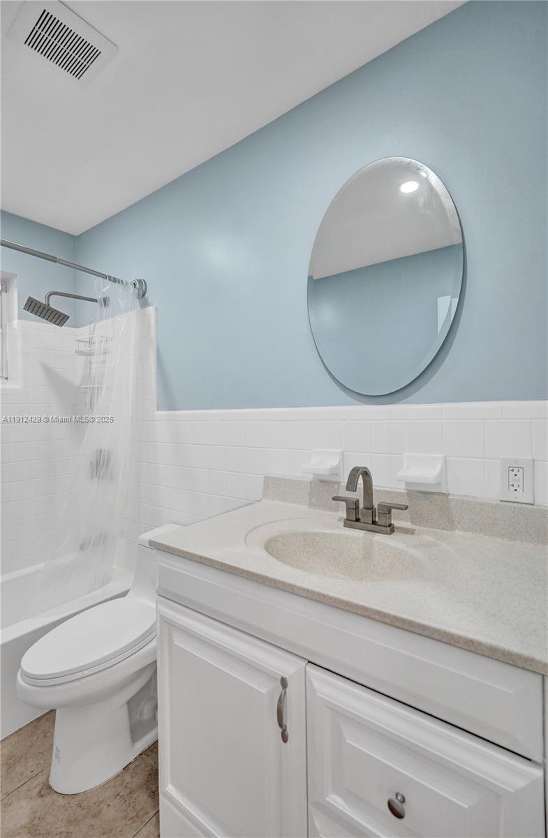720 Southeast 15th Street, Unit 2R Fort Lauderdale, FL 33316 - Photo 21 of 33 a bathroom with a sink a toilet and a mirror